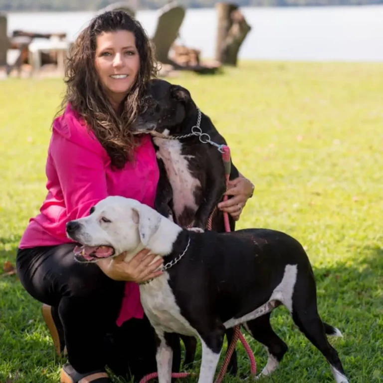 Woman sitting with 2 dogs